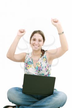 woman with laptop sitting on the floor and celebrating her success isolated
