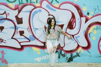 Girl against grafitti wall