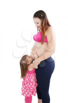 Nice Caucasian woman pregnant with her daughter on the background 