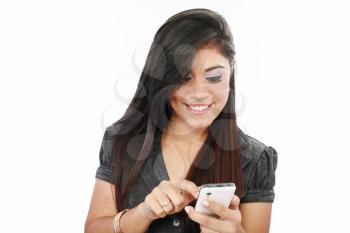 portrait of a happy young business woman texting from her cellphone against white background