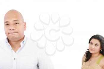 young couple on white background having a dispute. Focus on man