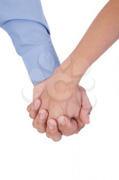 Closeup of young affectionate couple holding hands over white background. 
