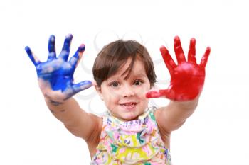 beautiful little girl with her hands in the paint 