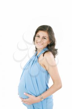 Portrait of happy pregnant woman with hands on stomach isolated over white background 

