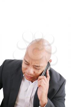 Portrait of a serious businessman talking on mobile phone over white background 