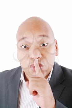 Black man showing silence gesture with finger on his lips. All on white background