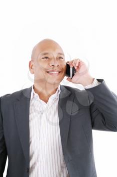 A smiling African American business man talking on cellphone over white background