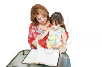 Minority woman and her daughter reading the Bible 
