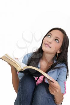 Beautiful young woman holding a Bible