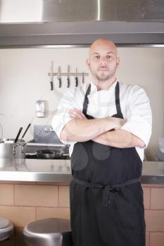 Male Chef Standing Next To Cooker In  Kitchen