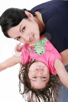 Mother playing with her daughter and holding her upside down