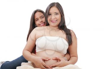 pregnant woman and her daughter making a heart sign