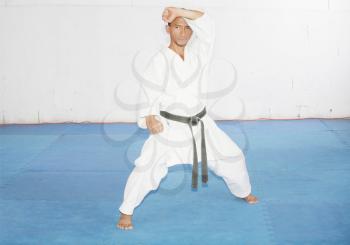 Black belt karate man in defending position