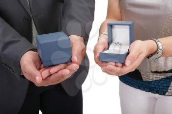 Couple hands holding boxes with rings. Valentines day and engagement concept.