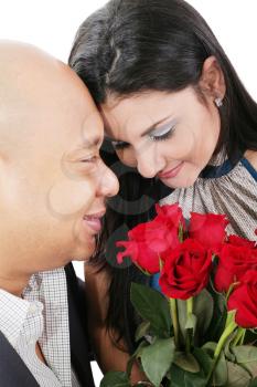 Close up of couple holding a bouquet of red roses