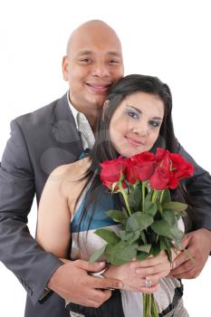 Portrait of happy couple with flowers, looking at camera. 