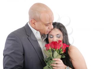 woman enjoys the smell given of a bouquet of roses. Happy couple in love. Valentines day Concept. 