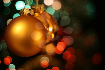 Christmas golden ball with a red and green light blur creating bokeh in the background