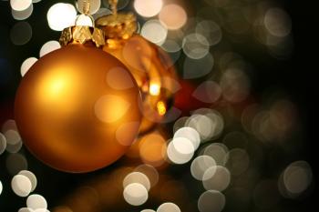 Christmas golden ball with a white light blur creating bokeh in the background