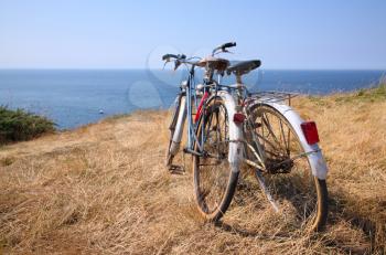 Two attached bicycles near the coast, during holidays in France.