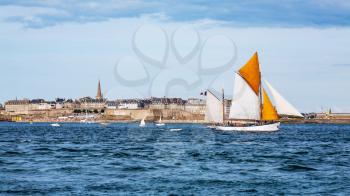 Seaside view of Saint Malo and a sailboat, Brittany, France