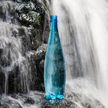 Blue bottle of mineral water in the nature