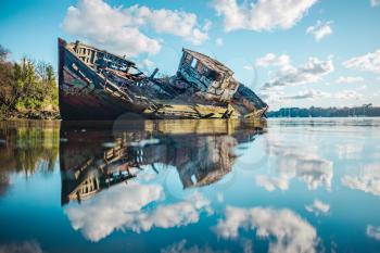 Wreck of a wooden fishing boat abandoned in the clouds, Saint-Malo, France