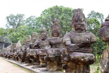 Angkor Thom (ancient royal city) entrance bridge with row of demon figures. Siem Reap, Cambodia.