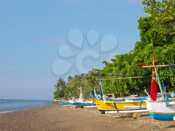 Bali island coast with small fishing boats on the beach, Indonesia.