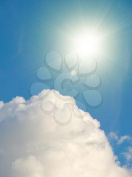 Sky vertical background with heap cloud and shining sun.