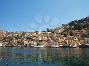 View at Symi town with multiple colorful houses, Greece.