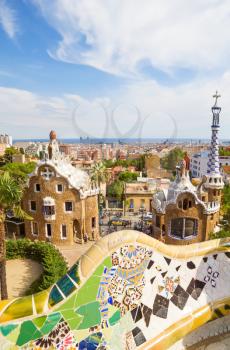 BARCELONA, SPAIN - SEPTEMBER 3: Park Guell main entrance pavilions on September 5, 2012 in Barcelona, Spain. View on Barcelona and main entrance pavilions of Park Guell from the main terrace with the 