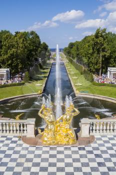 SAINT_PETERSBURG, RUSSIA - JULY 27: Peterhof palace park main channel with fountains on July 27, 2013 in Saint-Petersburg, Russia. Peterhof Palace park is one of the most remarkable in Europe laid out