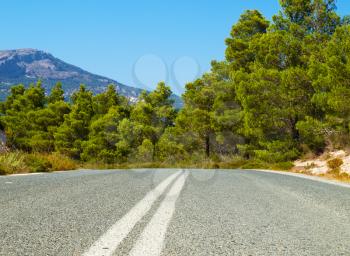 The asphallt road leading through the Rhodes island, Greece.