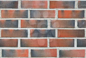 Burned red lining brick wall seamless background.