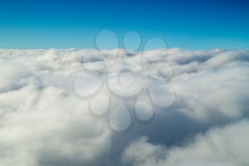 Cumulus cloudscape with blue sky above natural background.