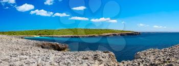 Cala des Talaier beach sea cove in sunny day panorama, Menorca island, Spain.