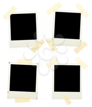 Royalty Free Photo of a Series of Instant Photos Taped to a Board