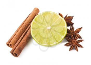 Royalty Free Photo of a Lime With Cinnamon Sticks and Anise Stars