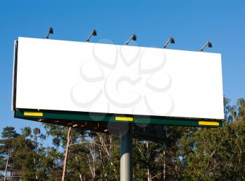 Royalty Free Photo of a Blank Billboard among the Trees