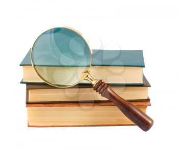 Royalty Free Photo of a Stack of Old Books with a Magnify Glass