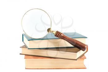 Royalty Free Photo of a Magnifying Glass and a Stack of Books