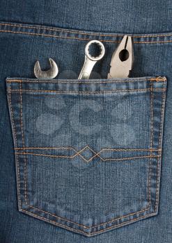 Royalty Free Photo of Pliers and Wrenches in the Pocket of Denim Jeans