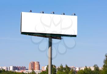 Royalty Free Photo of a Blank Billboard Against a Cityscape Background