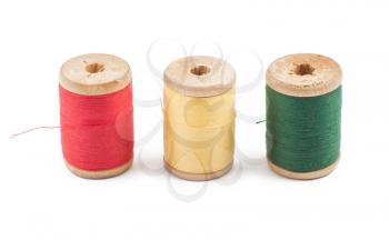 Royalty Free Photo of Three Wooden Colored Thread