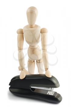 Royalty Free Photo of a Wooden Mannequin Holding onto a Stapler