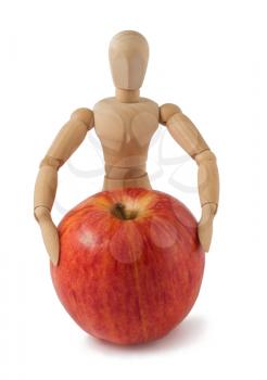 Royalty Free Photo of a Wooden Mannequin and an Apple