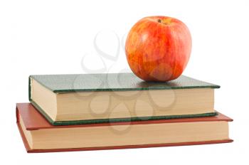 Royalty Free Photo of a Single Apple on Top of Hardcover Books