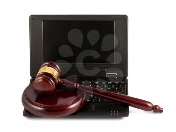 Judges wooden gavel on a black laptop computer keyboard