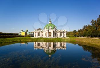 The Grotto Pavilion with reflection in water at the museum-estate Kuskovo, Moscow, Russia